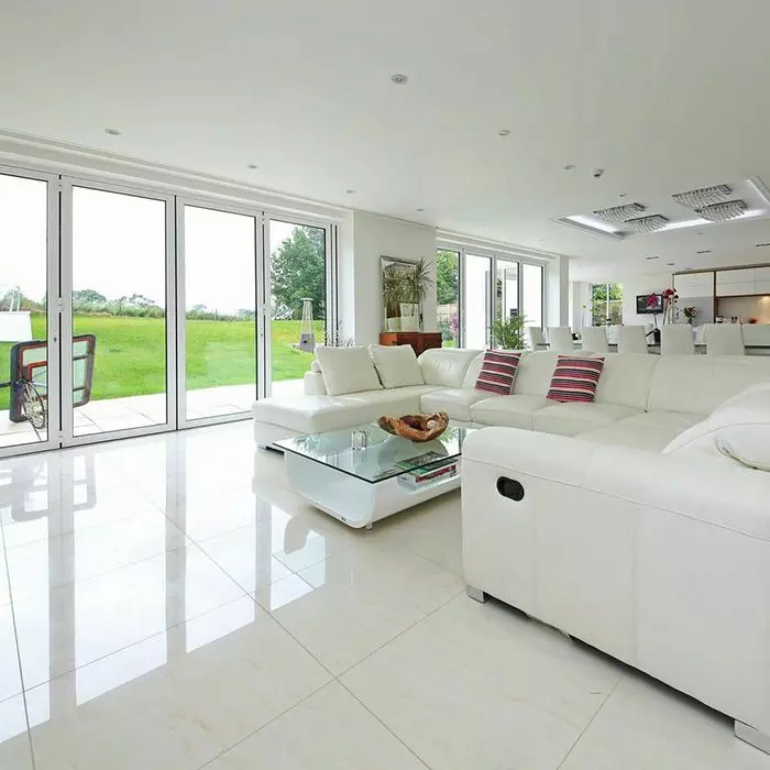 Super Ivory polished porcelain tiles installed in a bright living space